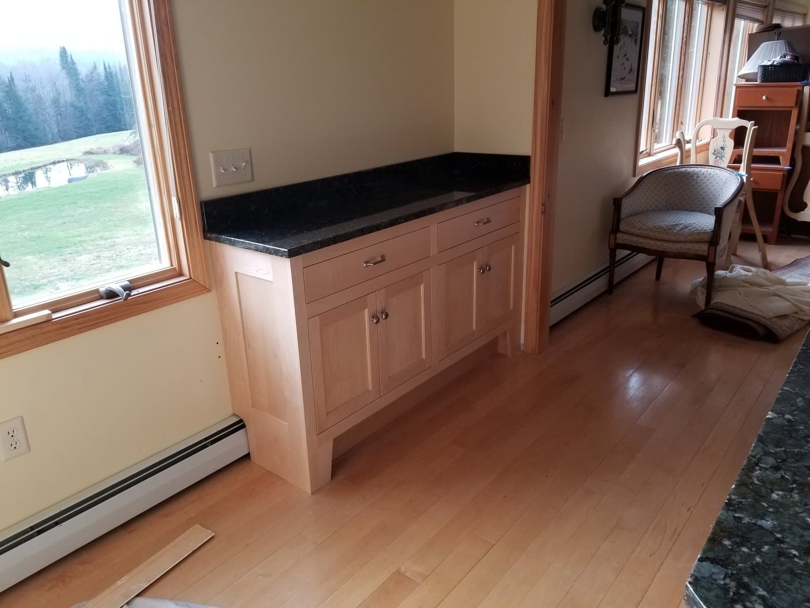 Cherry base run under a window, black counter