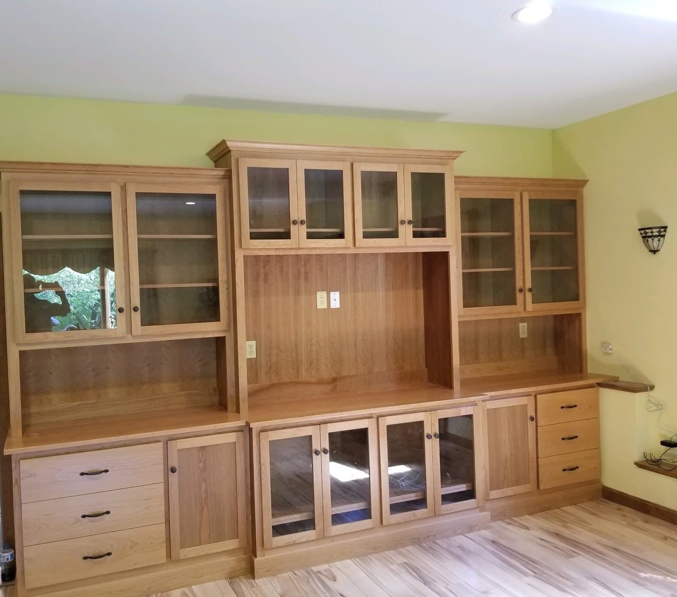 Built-in entertainment wall with glass-front uppers